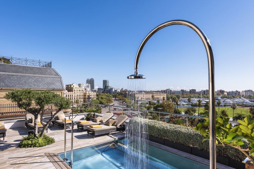 Luxury boutique hotel overlooking Barcelona's Gothic Quarter, with elegant Mediterranean-style architecture and stunning cityscape view from a chic balcony terrace