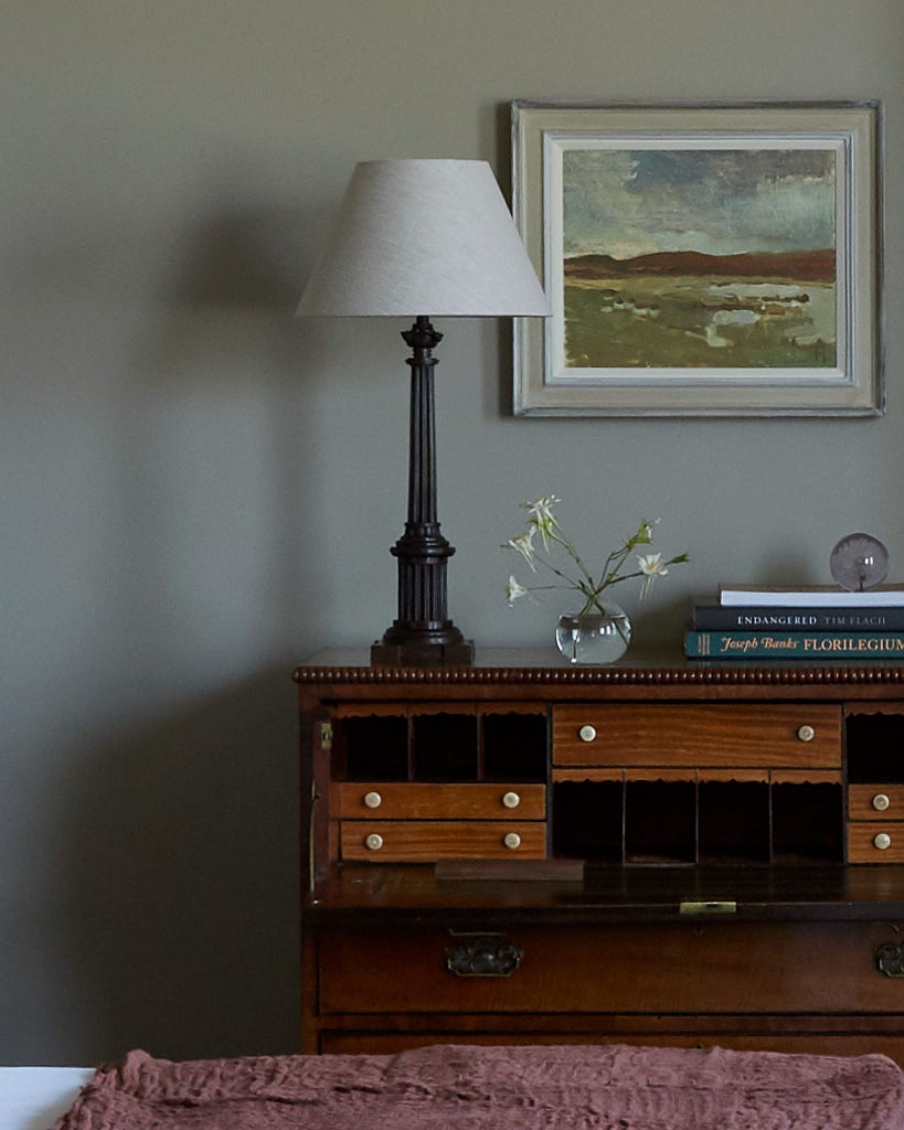 Elegant lake-view room at luxury countryside hotel featuring soft neutral tones, plush bedding, and expansive windows overlooking serene natural landscape in United Kingdom