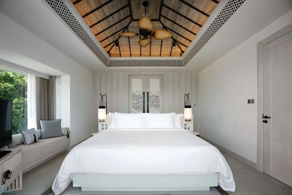 Spacious two-bedroom suite with private infinity pool overlooking Krabi's ocean, featuring modern Thai decor and floor-to-ceiling windows