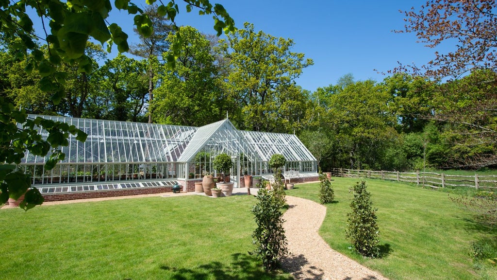 Rustic-chic luxury hotel nestled in New Forest, Hampshire, with elegant wooden exterior, verdant landscape, and refined country estate atmosphere