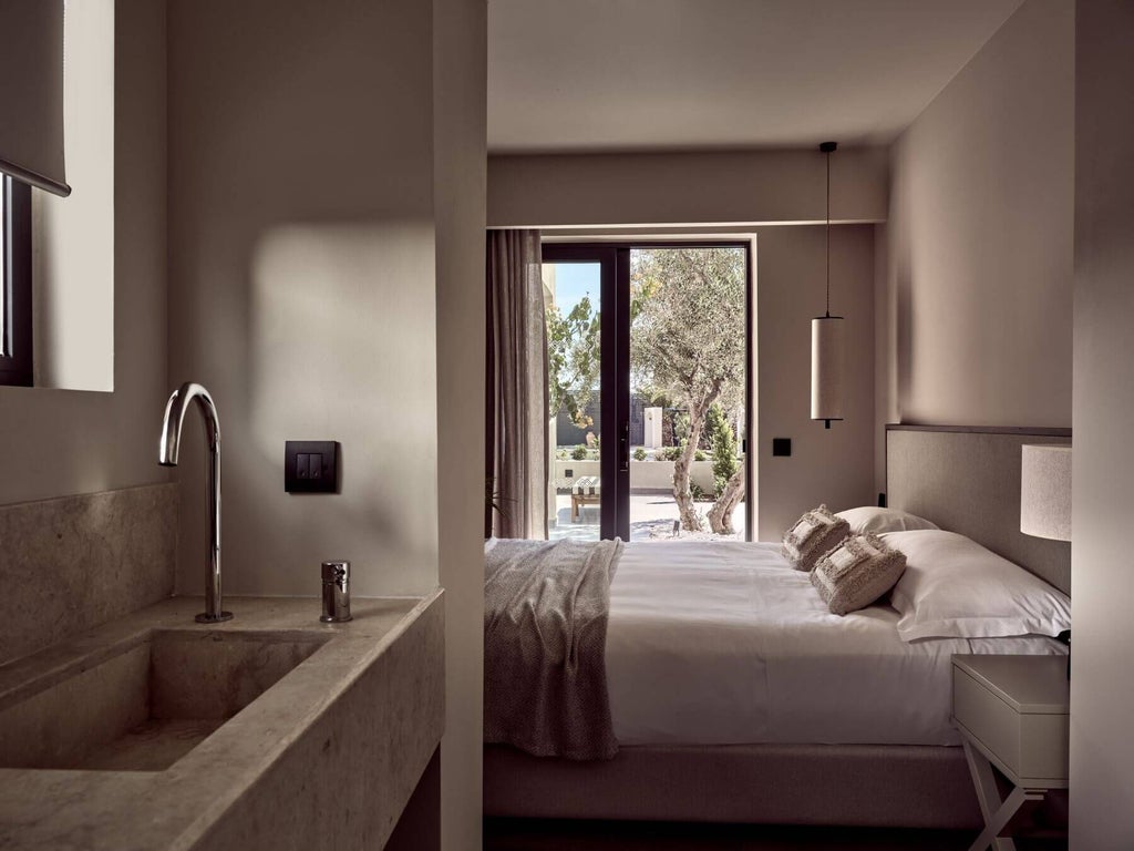 Luxurious king suite with private pool overlooking azure Mediterranean waters at seaside resort in Crete, featuring contemporary design and scenic coastal landscape