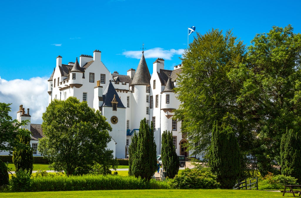 Historic Blair Castle with grand stone facade, elegant Scottish architecture, lush green estate grounds under soft daylight in scenic United Kingdom landscape