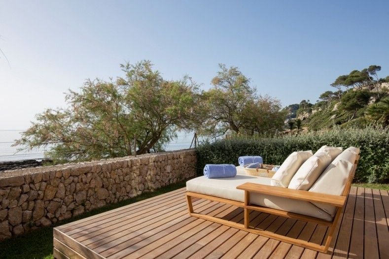 Luxurious grand suite with private garden and pool, overlooking azure Mediterranean waters near scenic Spanish coastline