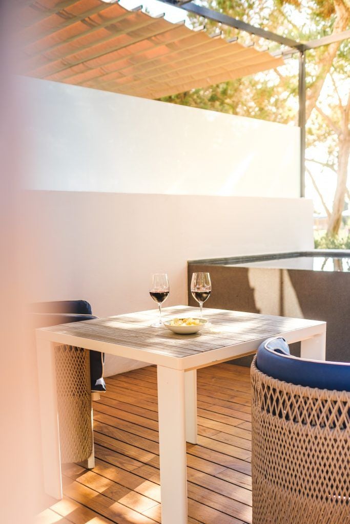 Luxurious poolside corner at Gecko Hotel & Beach Club, featuring sleek lounge chairs, vibrant blue pool, and modern Spanish coastal design elements