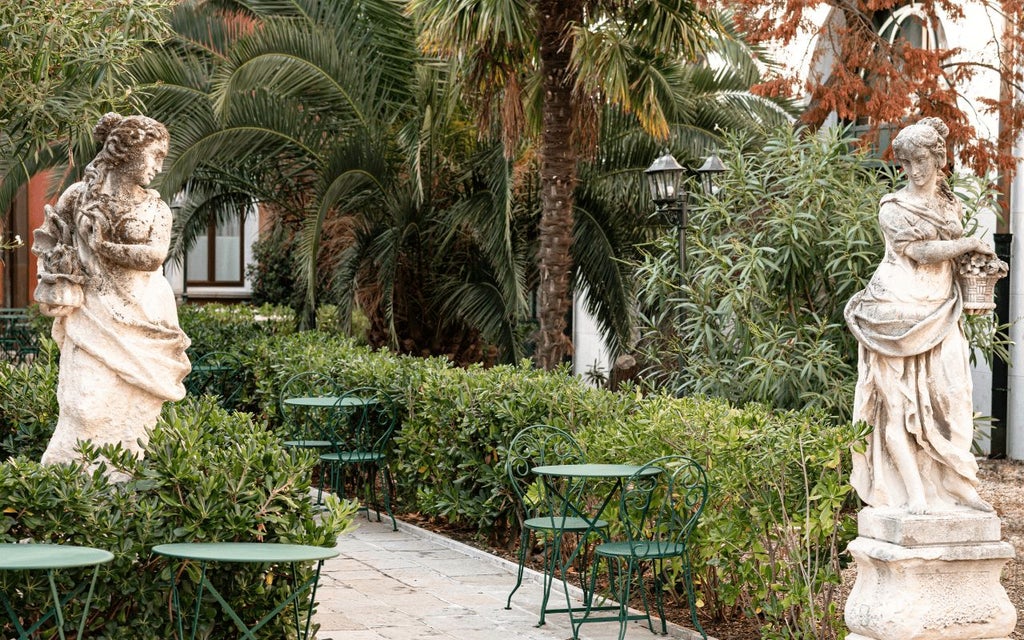 Elegant Italian palazzo hotel with ornate facade, soft golden lighting, and classic Venetian architectural details overlooking a serene canal setting