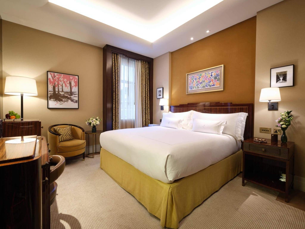 Elegant Superior Grand Room at scenset hotel, featuring plush king bed, luxurious cream and gold decor, and refined classic British interior design