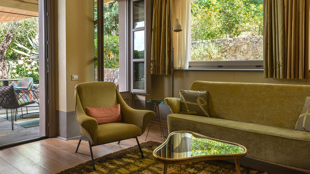 Elegant Tuscan boutique hotel room with rustic wooden floors, soft neutral linens, and warm golden sunset light filtering through sheer curtains