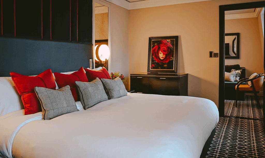 Elegant green and cream luxury hotel suite with plush furnishings, ornate artwork, and sophisticated decor in The Mayfair Townhouse, United Kingdom