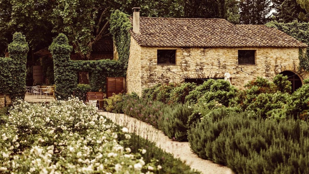 Elegant stone-facade boutique hotel in Provence with sun-drenched terrace, lavender fields, and rustic French countryside charm at golden hour