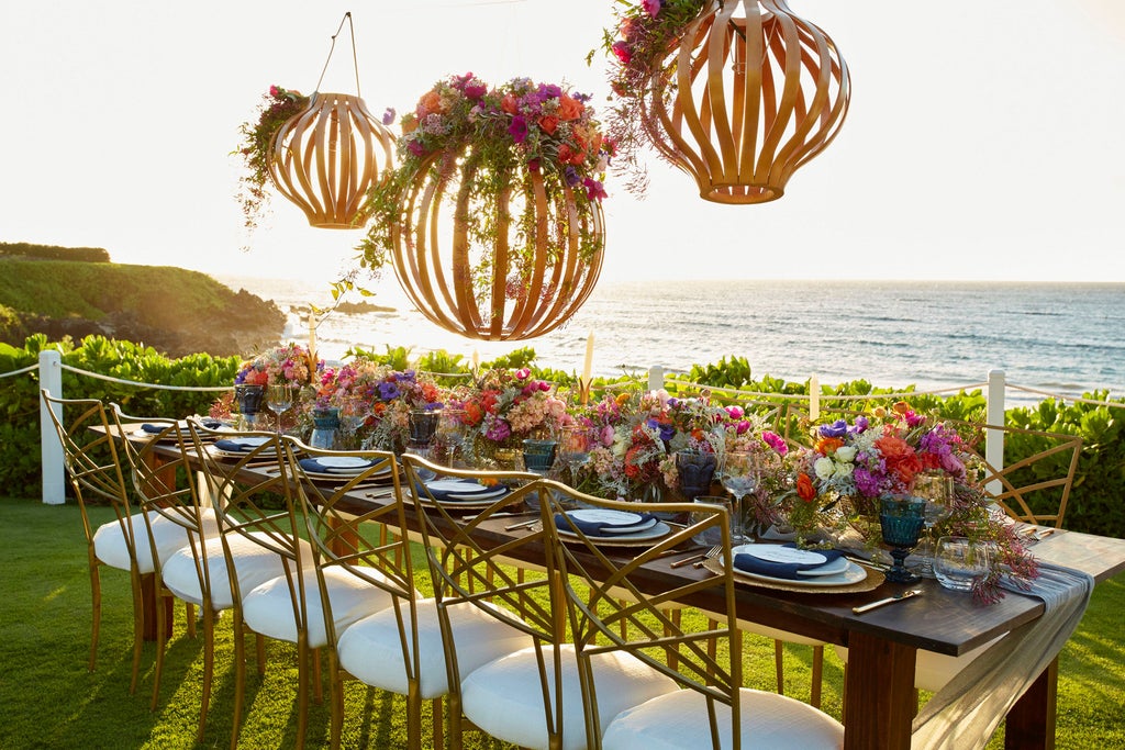 Beachfront Four Seasons resort in Maui with infinity pool overlooking Pacific Ocean, swaying palm trees and luxury cabanas at sunset