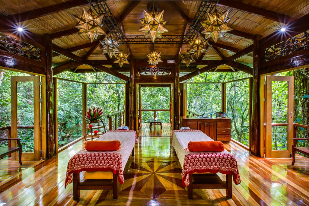 Private luxury villa with infinity plunge pool overlooking lush Costa Rican rainforest, featuring modern outdoor furniture and tropical plants