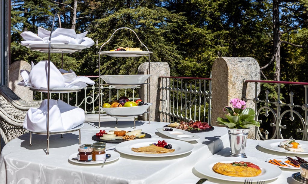 Luxurious Vidago Palace Hotel nestled in lush Portuguese landscape, featuring elegant white architecture, manicured gardens, and pristine spa surroundings at golden hour