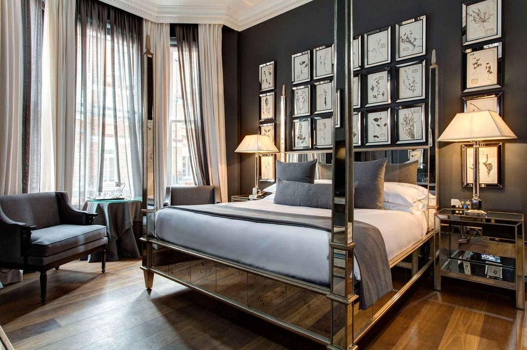 Elegant deluxe hotel room with plush white bedding, contemporary furnishings, soft neutral tones, and expansive city view at The Franklin, United Kingdom