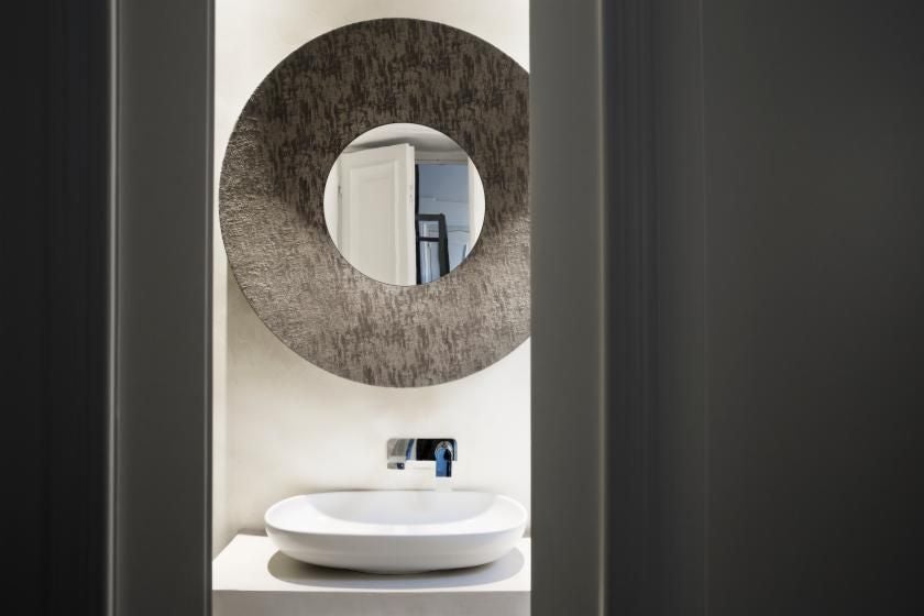 Elegant luxury hotel room near Piazza di Spagna, featuring refined Italian decor, plush white bedding, and soft natural light streaming through large windows