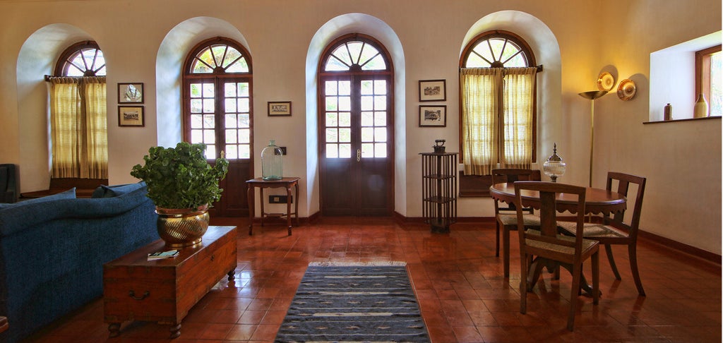 Historic colonial-style waterfront hotel in Fort Kochi, with ornate white facade, arched windows, and traditional Kerala architecture details