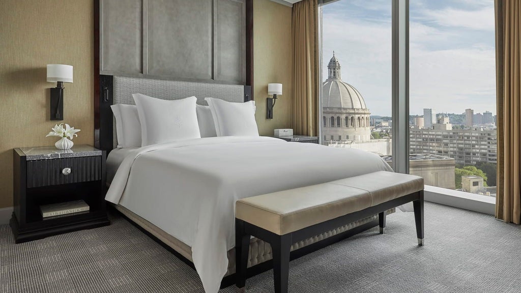 Spacious Four Seasons executive accessible suite with modern design, plush bedding, elegant furnishings, and city views in downtown Boston hotel room