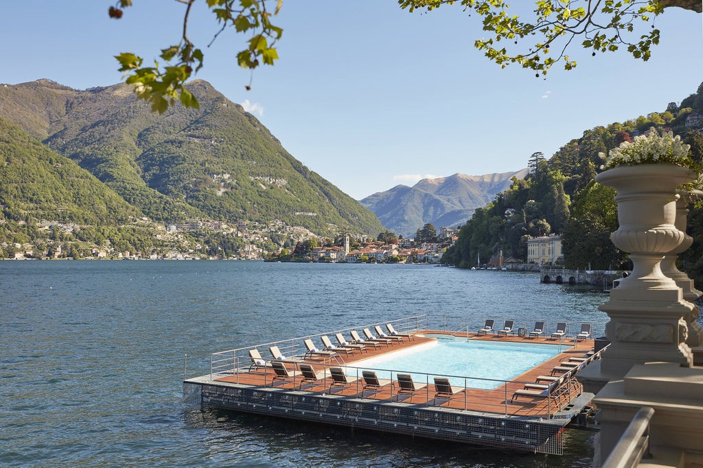 Elegant lakeside terrace of Mandarin Oriental with stone balustrades, manicured gardens and sweeping views over Lake Como at sunset