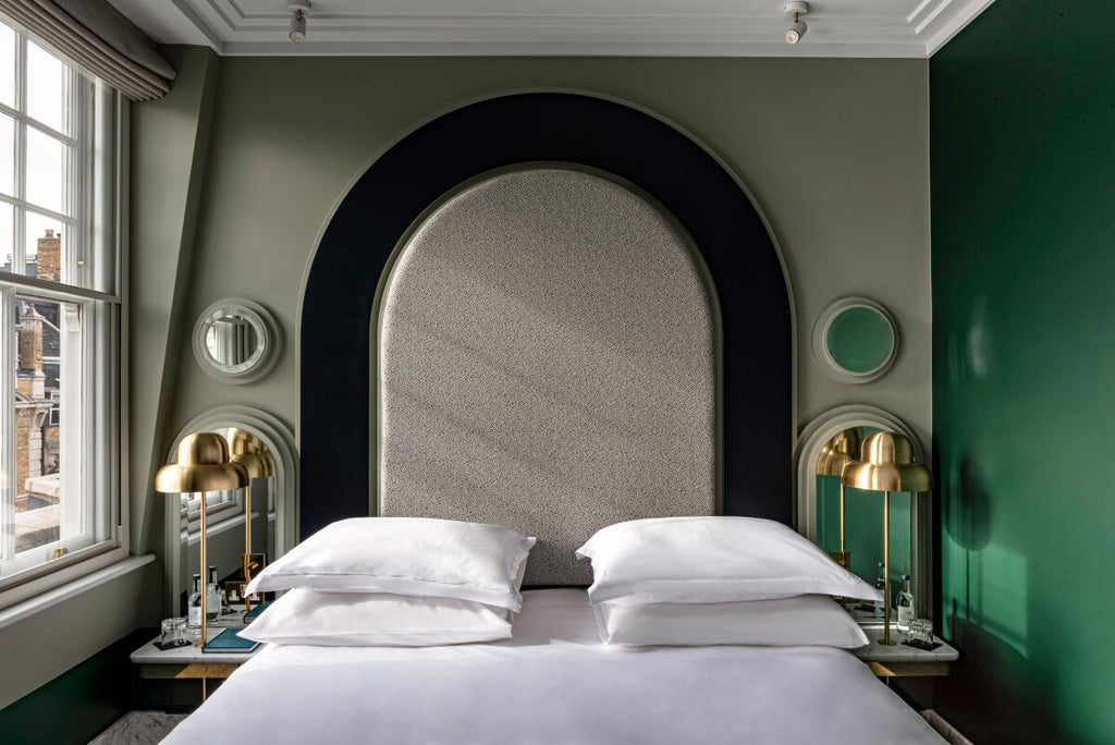 Elegant standard room at a luxury boutique hotel in Little Covent Garden, featuring plush bedding, soft neutral tones, and sophisticated urban-chic design elements