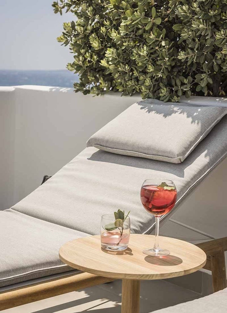 Luxurious white-washed Mykonos suite with private plunge pool, overlooking azure Aegean Sea, featuring minimalist design and elegant outdoor terrace