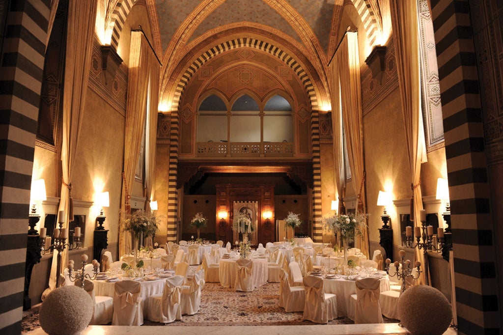 Elegant 16th-century Florentine palazzo with ornate Renaissance facade, manicured gardens, and classical Italian architecture at sunset