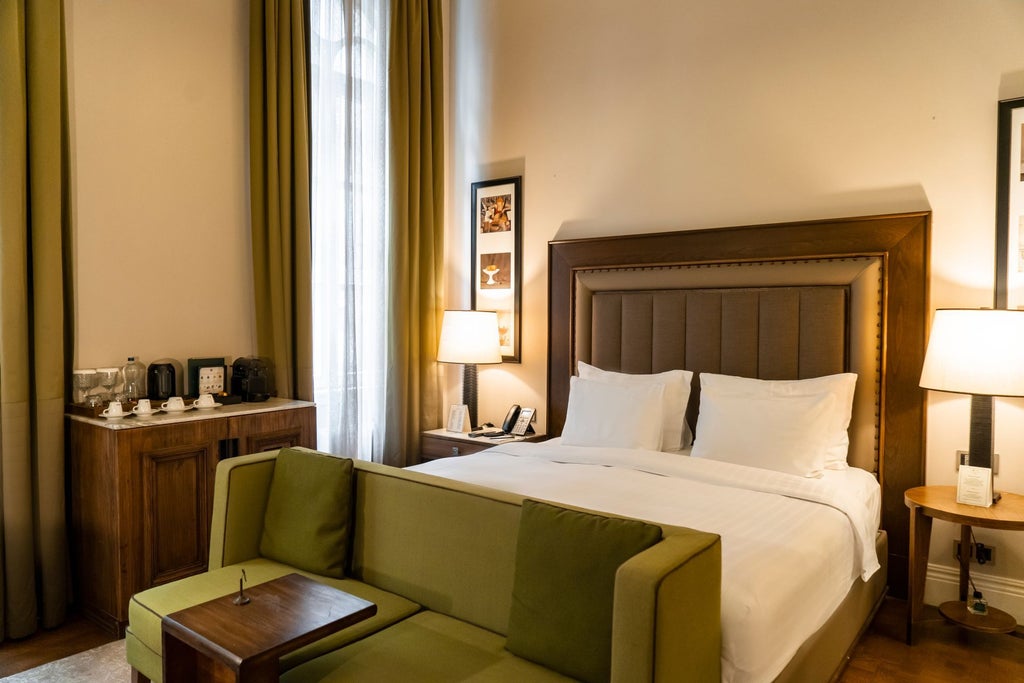 Elegant deluxe king room at a luxury boutique hotel in Istanbul, featuring plush bedding, rich wood furnishings, and sophisticated contemporary design