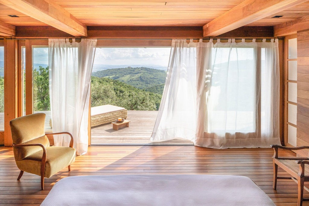 Luxurious spa suite at Castello di Vicarello, featuring elegant stone walls, plush white linens, and panoramic Tuscan countryside views through arched windows.