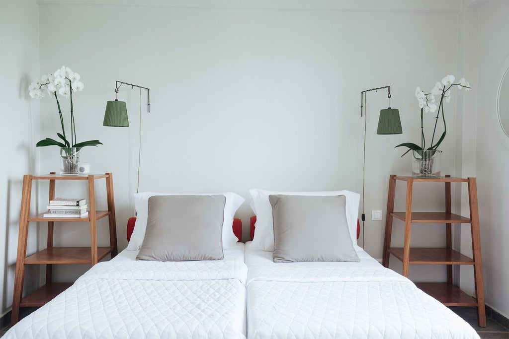 Elegant two-story maisonette at Emelisse Resort, featuring white-washed walls, wooden accents, private balcony overlooking lush Kefalonian landscape