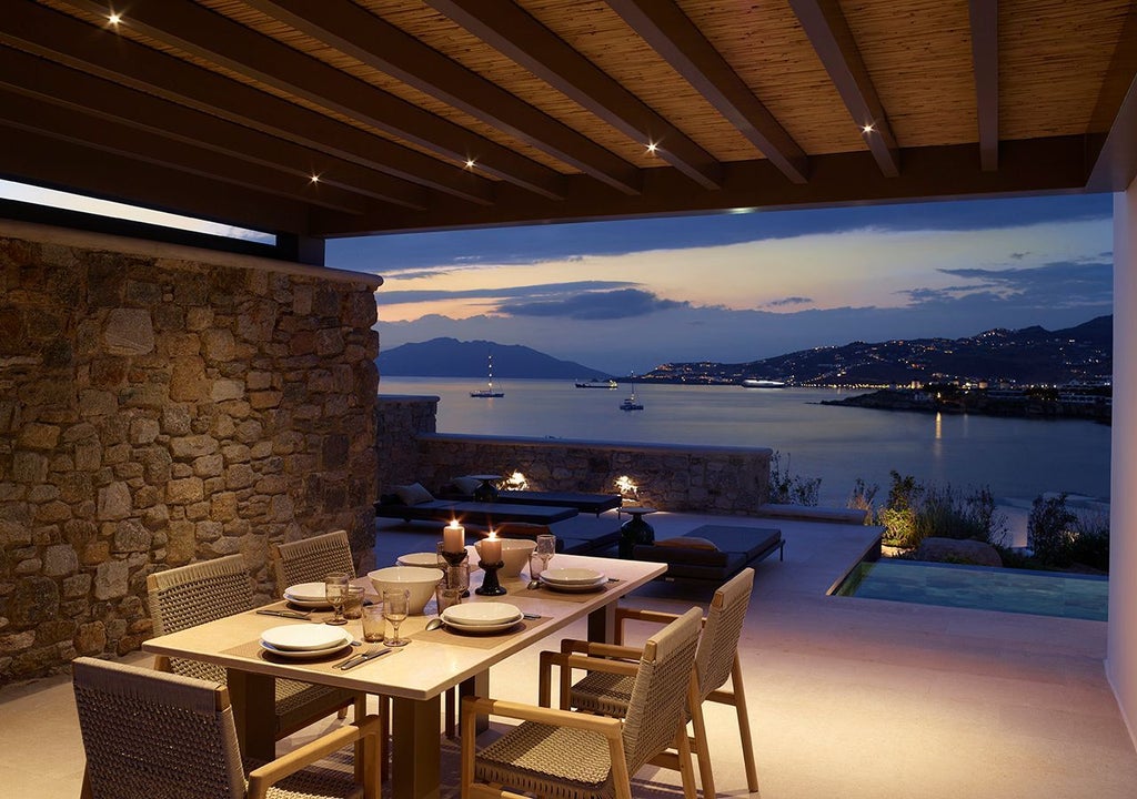 Luxurious three-bedroom villa in Mykonos with panoramic Aegean Sea views, private heated pool, and modern Mediterranean architectural design