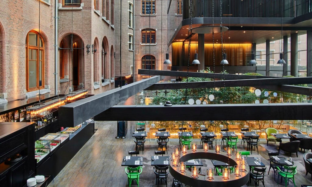 Luxurious glass-fronted Scenset Conservatorium Hotel in Amsterdam, showcasing modern architectural design with elegant glass walls and contemporary urban setting