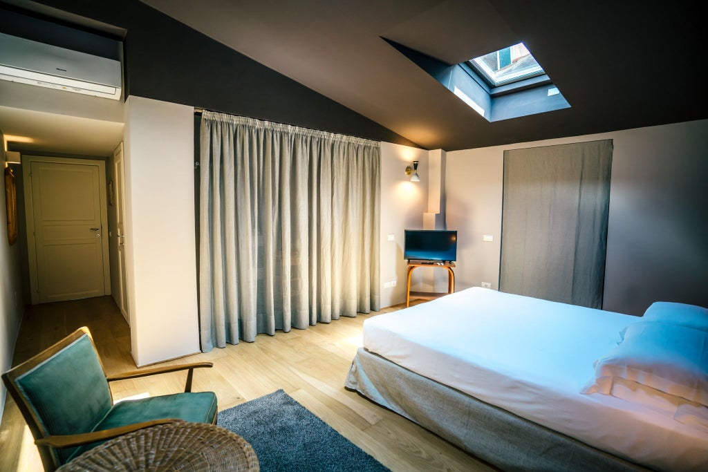 Minimalist Italian loft room with sleek wooden floors, contemporary design, large windows overlooking Tuscan landscape, and modern furniture in neutral tones