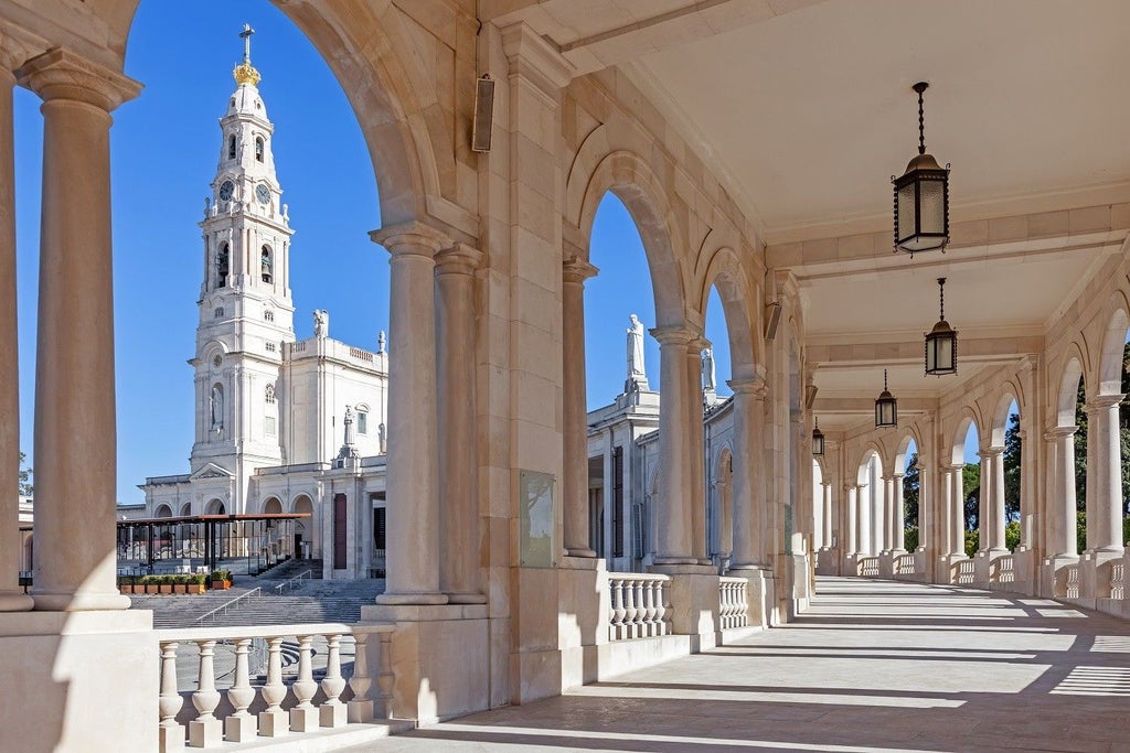 Serene sanctuary of Fatima, Portugal, with ornate white basilica, pilgrims in reverent pose, soft golden sunlight illuminating historic religious landmark