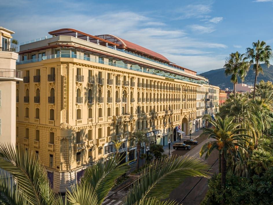 Elegant Art Deco façade of Anantara Plaza Hotel in Nice with ornate balconies, grand windows and classical French architecture bathed in sunlight