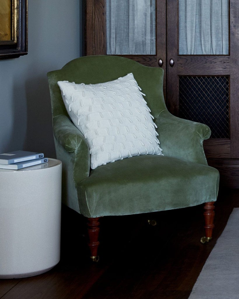 Elegant lake-view room at Heckfield Place, featuring soft neutral tones, contemporary furniture, and expansive windows overlooking lush British countryside landscape