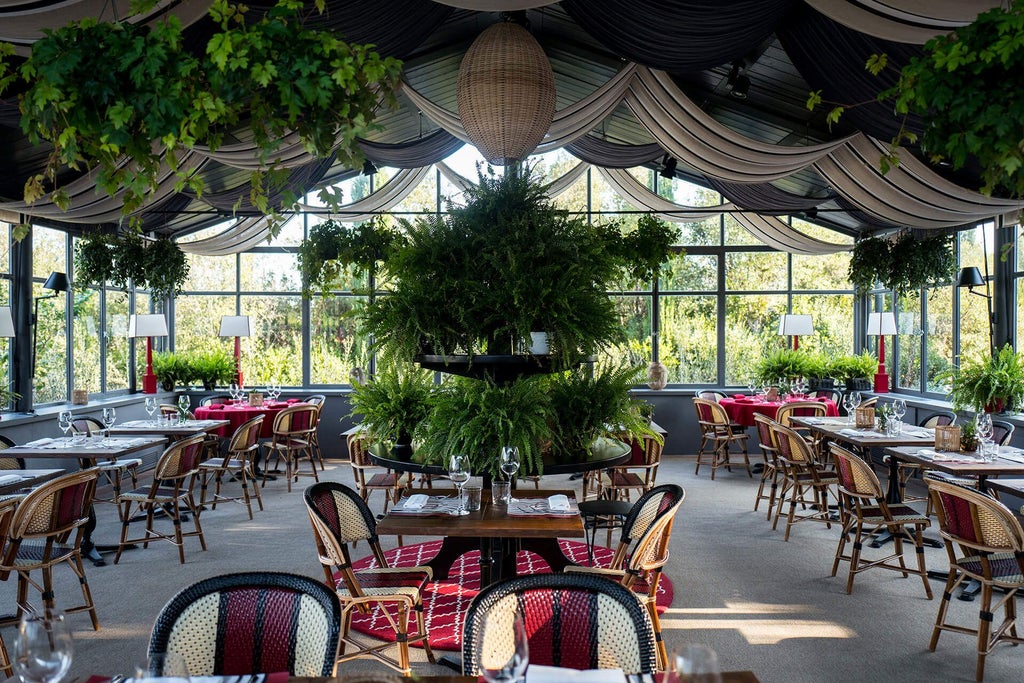 Elegant stone-walled rustic Italian hotel with terracotta roof, lush Tuscan landscape, manicured gardens, and warm golden sunlight filtering through cypress trees