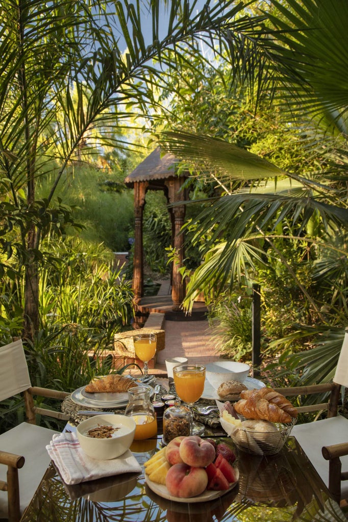 Luxurious stone countryside villa with rustic terracotta roof, surrounded by lush green landscape in scenic Portuguese rural setting