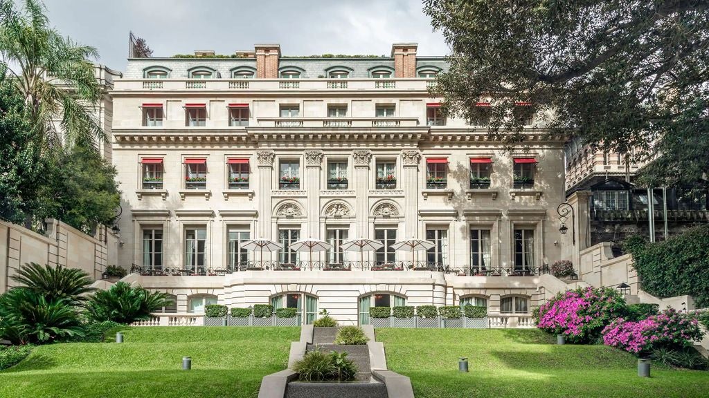 Elegant neoclassical palace hotel with manicured gardens, white facade, French-style architecture and ornate balconies in Buenos Aires