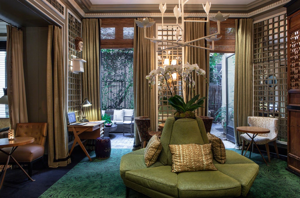 Elegant Parisian boutique hotel facade with soft neutral tones, intricate French architectural details, and subtle luxurious balconies near Saint-Sulpice square