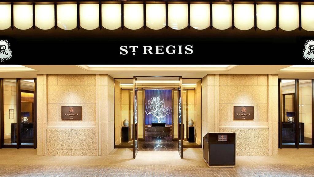 Opulent St. Regis DC hotel facade features Beaux-Arts architecture, ornate stone carvings, and grand entrance with signature awning