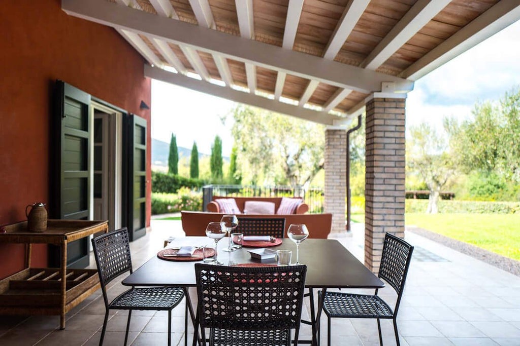 Rustic Tuscan boutique hotel with stone facade, surrounded by lush cypress trees and golden sunlight at golden hour