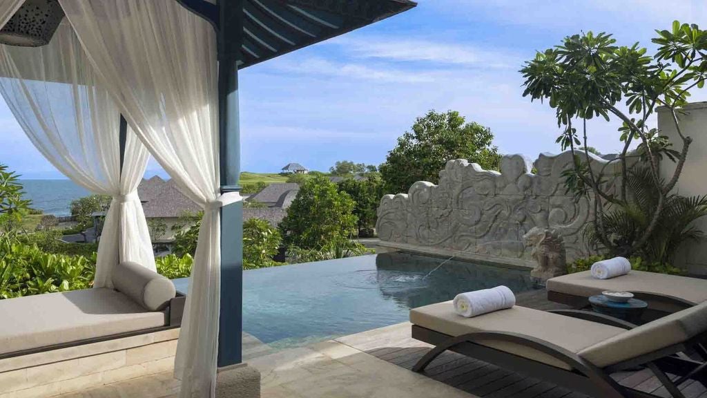 Luxurious beachfront villa with infinity pool overlooking Bali's ocean, featuring contemporary Balinese design and private terrace