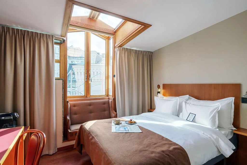 Elegant superior hotel room at Berns Hotel, Stockholm, featuring plush king bed, luxurious neutral tones, modern Swedish design with soft lighting and refined decor