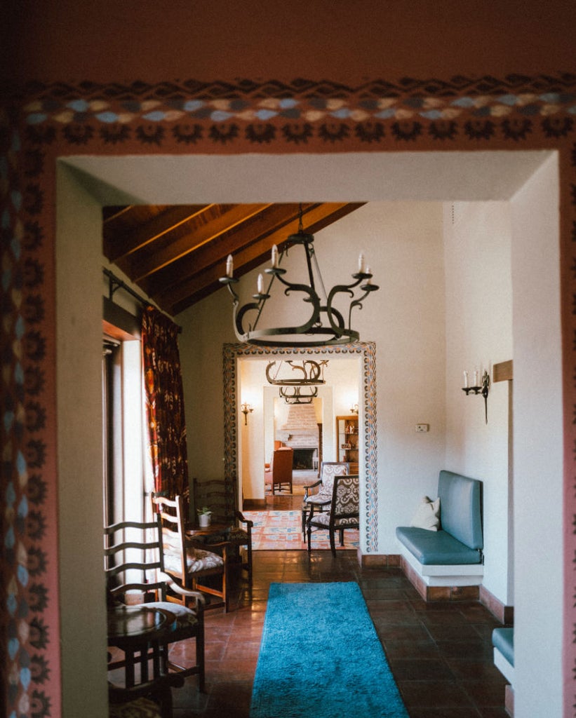 Cliffside villa with private plunge pool overlooking Peru's Colca Canyon, featuring stone pathways and lush mountain landscapes at sunset