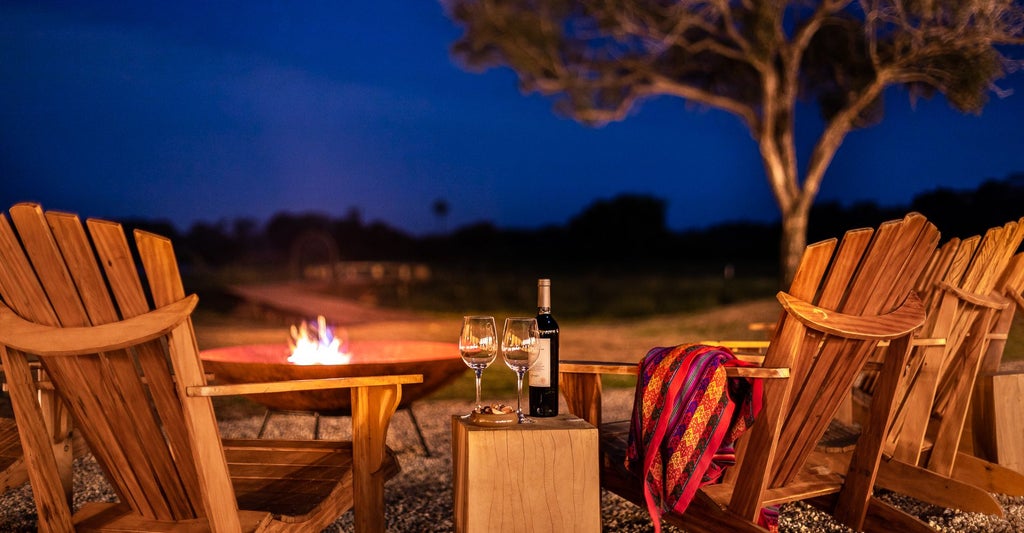 Luxurious master suite at Caiman Ecological Refuge, featuring elegant decor, plush bedding, and panoramic views of Brazilian wilderness landscape.