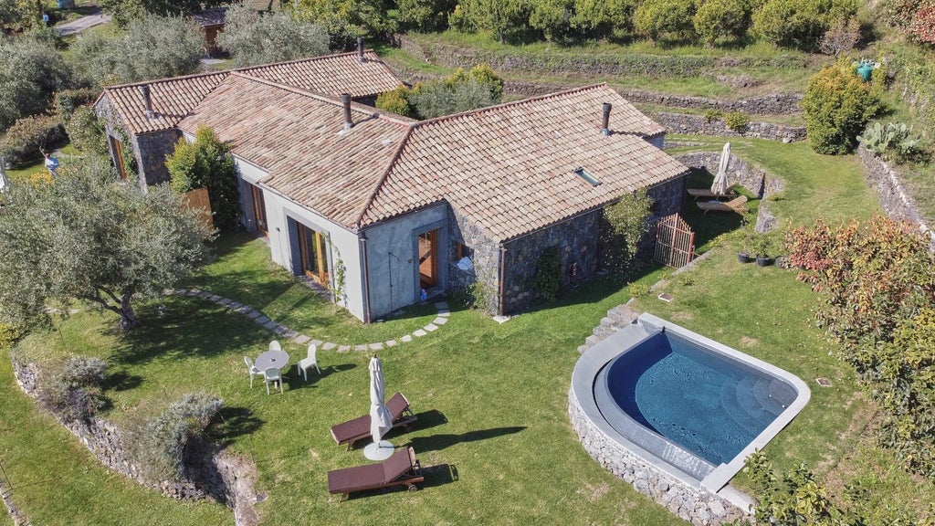 Luxurious four-bedroom pool villa at Monaci delle Terre Nere, featuring elegant Italian design and sweeping volcanic landscape views near Mount Etna