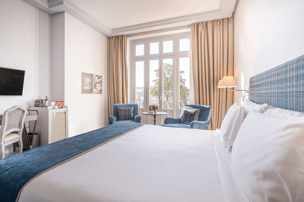 Elegant deluxe hotel room with panoramic palace views, luxurious white bedding, minimalist design, and soft natural lighting in Madrid, Spain