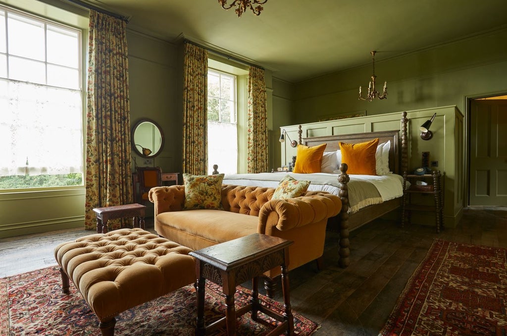 Luxurious rustic-chic hotel room at The Pig in South Downs, featuring plush king bed, vintage furnishings, and warm earthy tones with countryside view