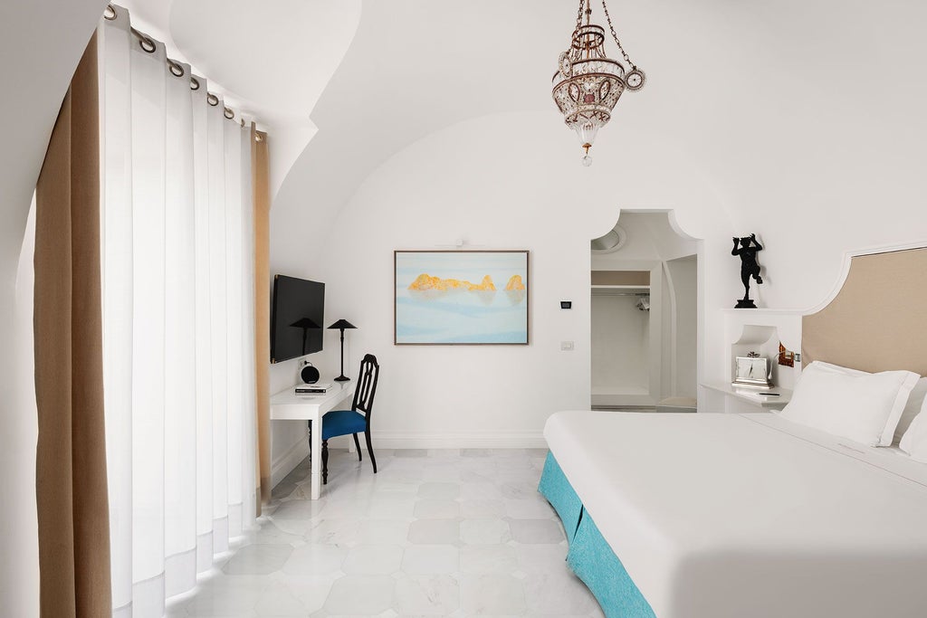 Elegant Italian coastal suite with panoramic Mediterranean views, luxurious marble bathroom, and classic seaside decor at Syrene hotel in Scenset