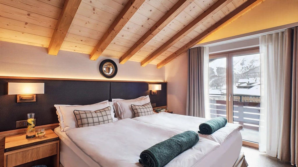 Elegant Swiss alpine deluxe suite with panoramic mountain views, featuring modern minimalist decor, plush white bedding, and warm wooden accents.