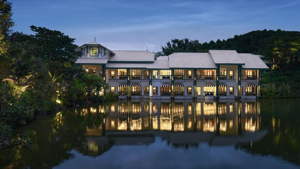 Luxurious InterContinental Khao Yai hotel nestled in lush Thai jungle, featuring modern glass architecture and a serene infinity pool