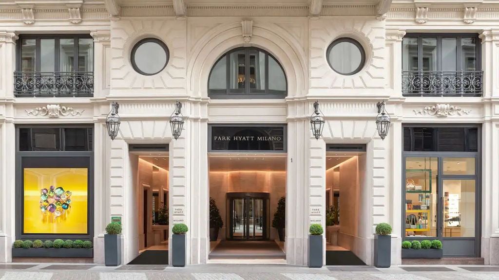 Opulent marble lobby of Park Hyatt Milan with crystal chandeliers, grand spiral staircase, and Renaissance-inspired architecture